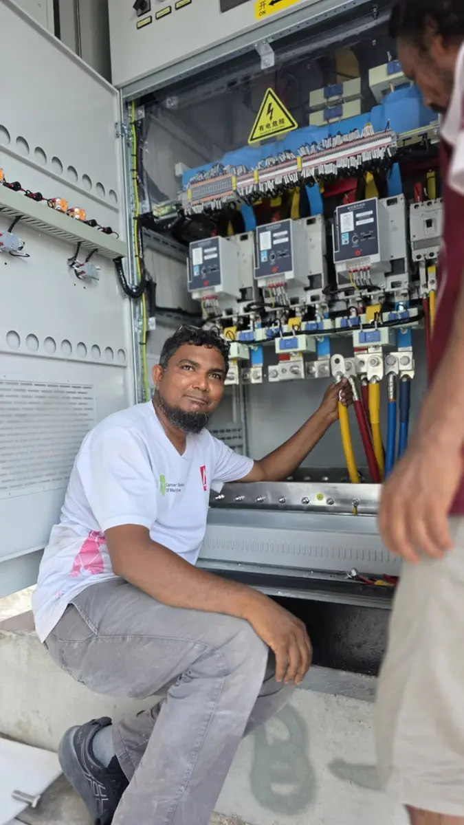 Sulthan Hameed, founder of SQ Depot, beside an electrical distribution panel